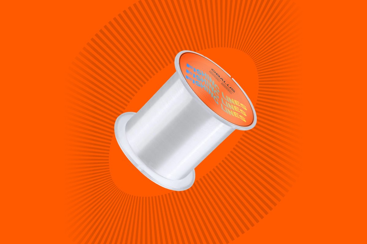 Spool of clear fishing line on an orange Obalus background