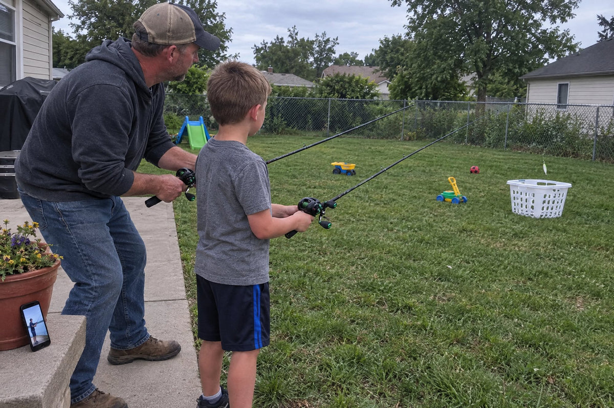A dad and his son practicing casts in the backyard