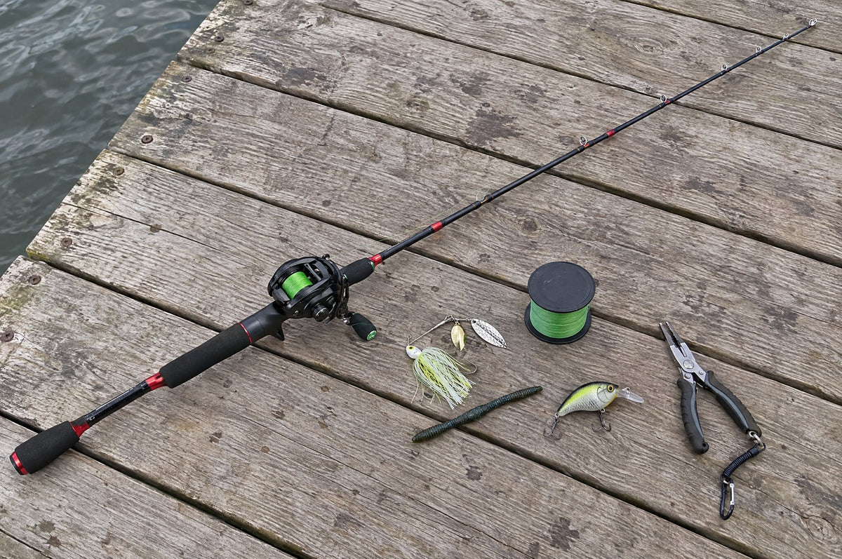 A casting rod with an Obalus reel, braided line and lures laid out on a dock