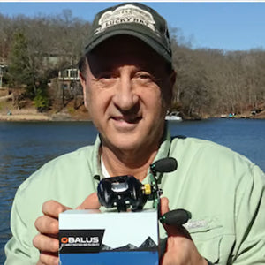 An Obalus owner at the lake holding his new reel in its box